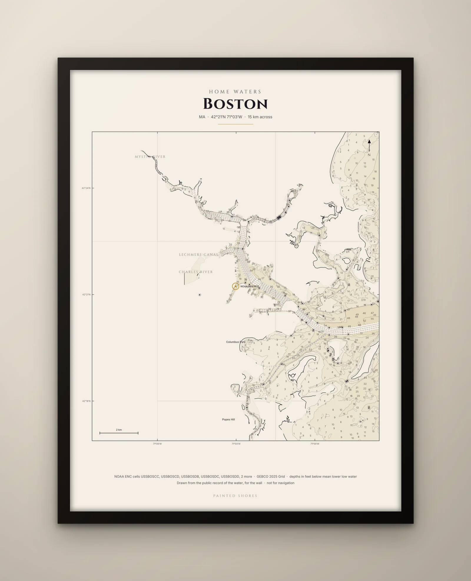 The framed print, 24 by 32 inches, tall: the home-waters chart of Boston Harbor on parchment, in a black frame behind glass, on a plaster wall